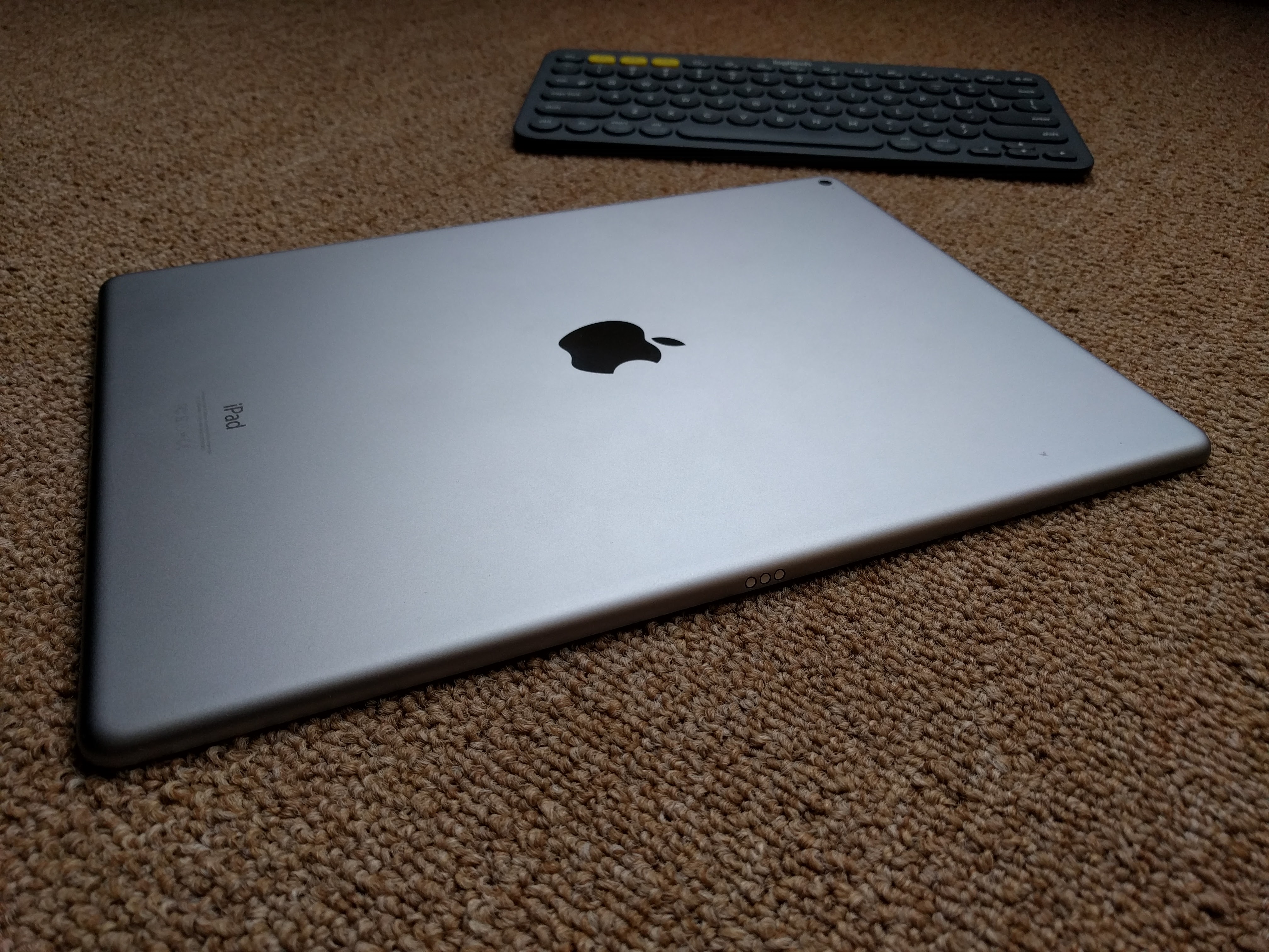 The back of the iPad Pro in the foreground. In the background is the Logitech K380 Bluetooth keyboard, which I've been using with the iPad Pro.