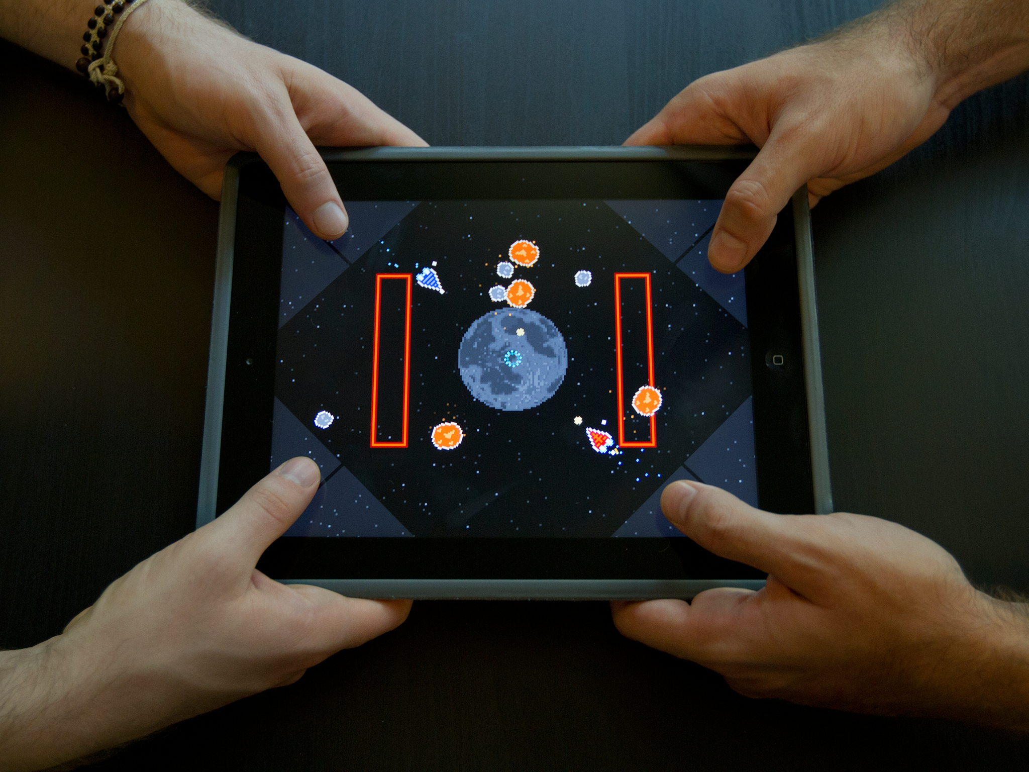 Two players battle it out on Astro Duel for iPad.