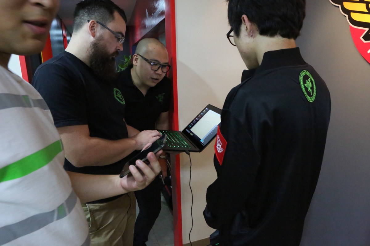 Drew Holt-Kentwell (with laptop) configures a Razer Synapse for an event. 