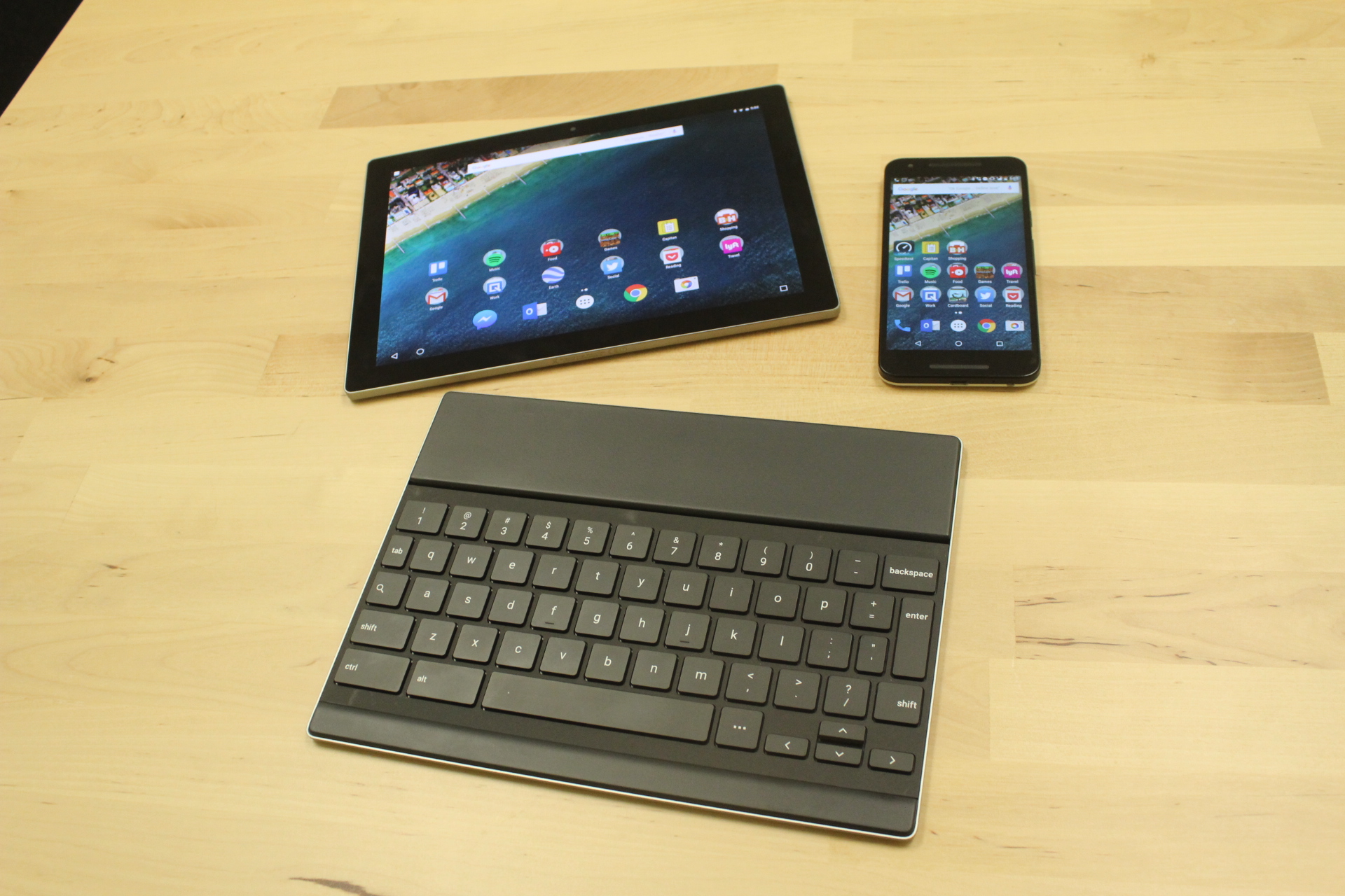 The Pixel C tablet, top left, the Nexus 5X smartphone, top right, and the Pixel C's matching keyboard, bottom.