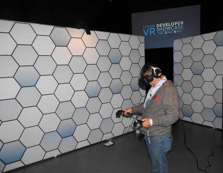 Dean Takahashi uses the hand controllers for the HTC Vive VR headset.