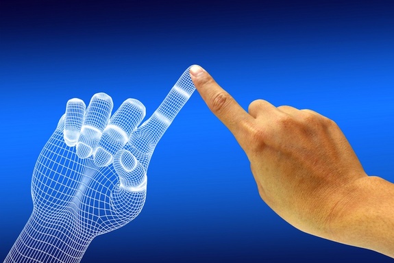 computer generated hand touching fingers with a human hand