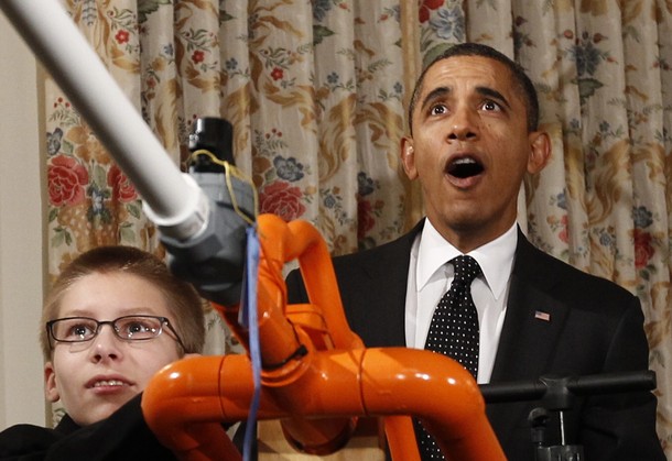 U.S. President Barack Obama reacts as Joey Hudy of Phoenix, Arizona launches a marshmallow from his Extreme Marshmallow Cannon in the State Dining Room of the White House during the second White House Science Fair .