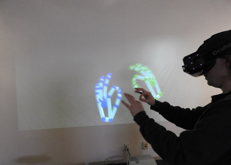 You can grab things with two fingers using Leap Motion in virtual reality.