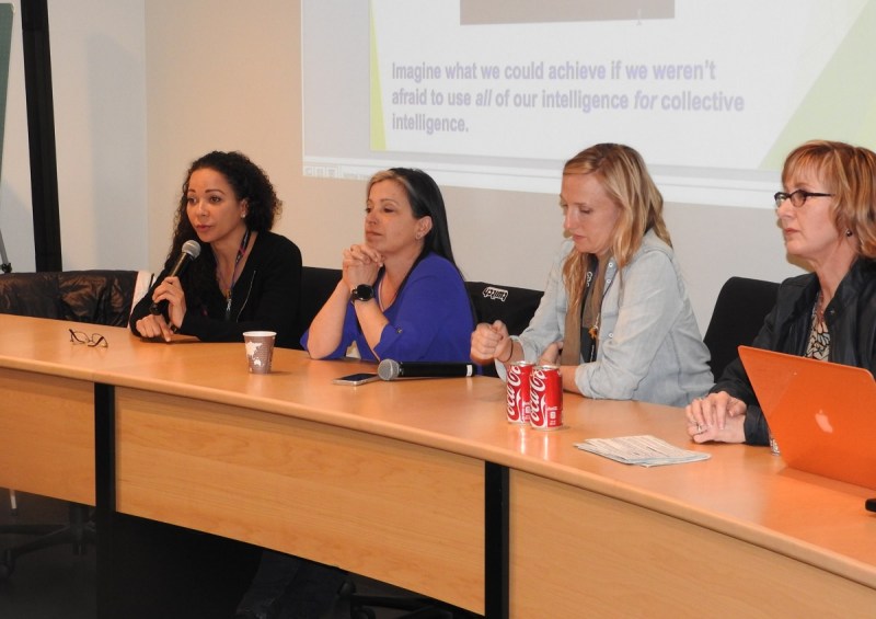 Nichol Bradford with microphone (left to right), Leslie Pirritano, Christina Heller, and Megan Gaiser.