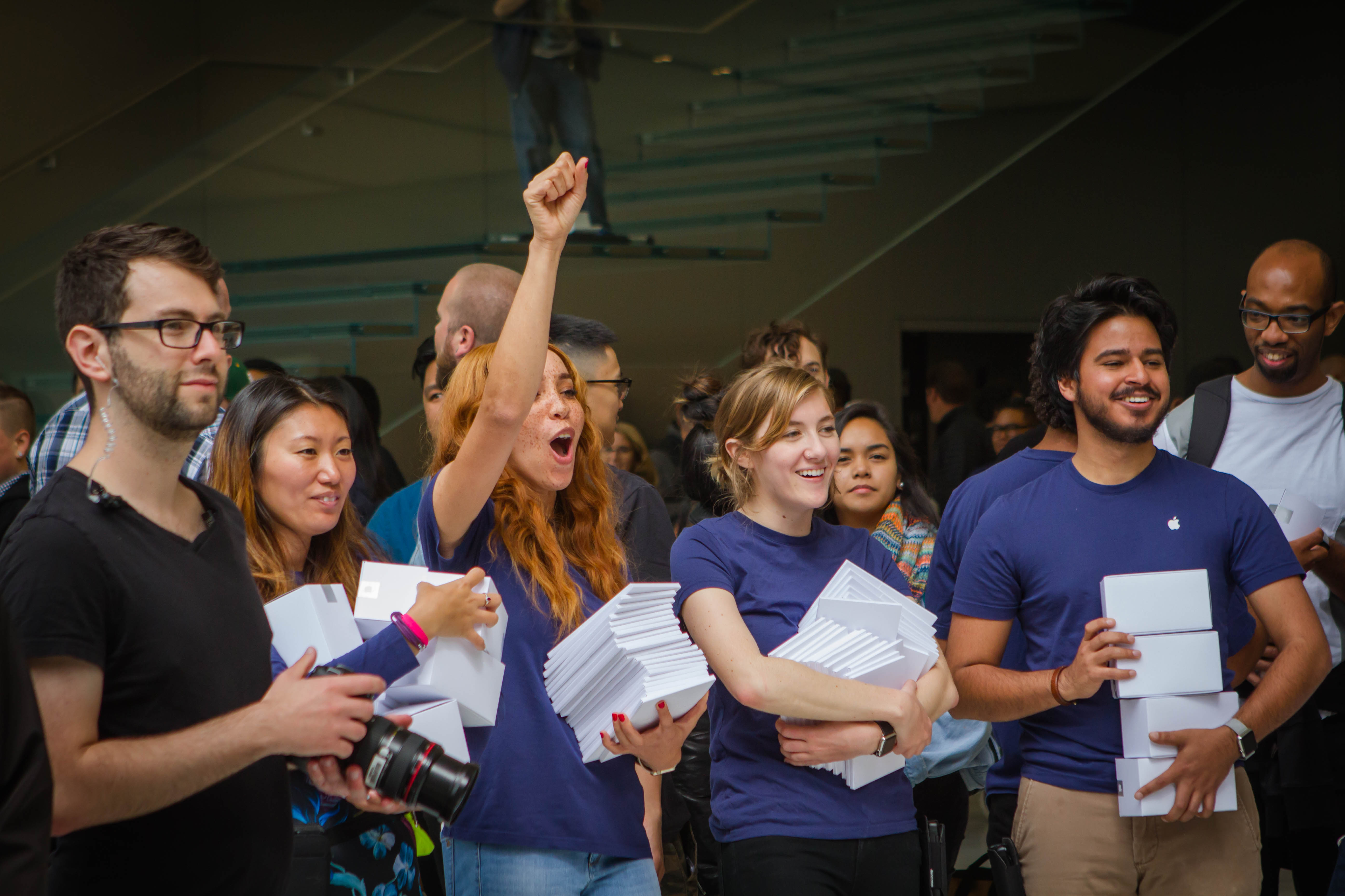 Apple employees cheer as people enter the company's new retail flagship store in San Francisco, Calif. on May 21, 2016.