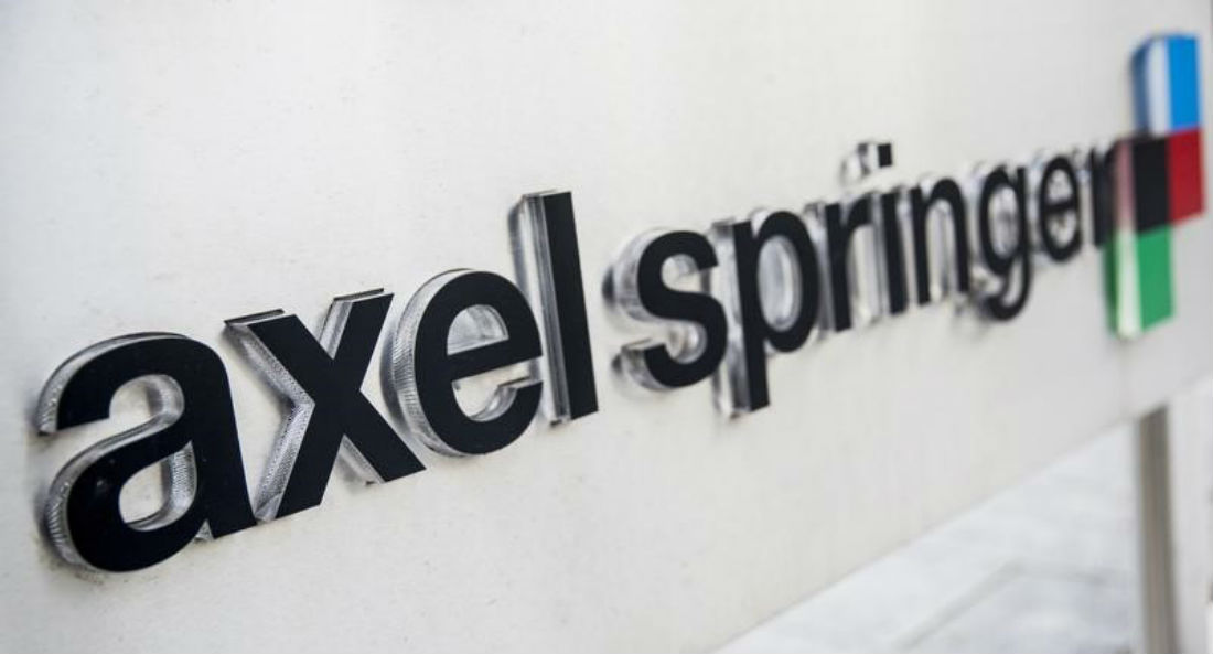 The logo of the German publisher Axel Springer is seen outside its headquarters in Berlin in this August 7, 2013 file photo.