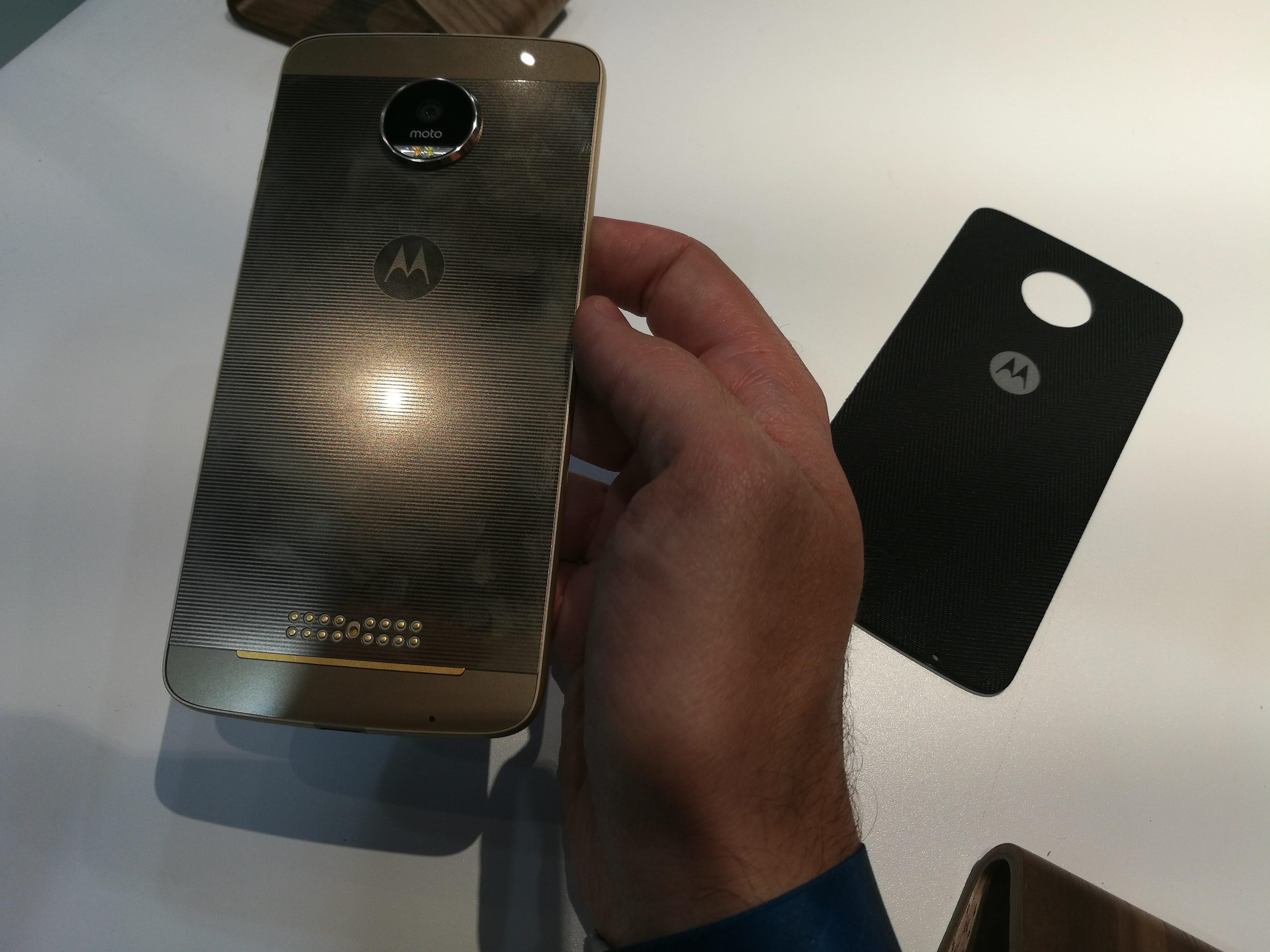 Lenovo's Moto Z, and an attachable backing on the right.