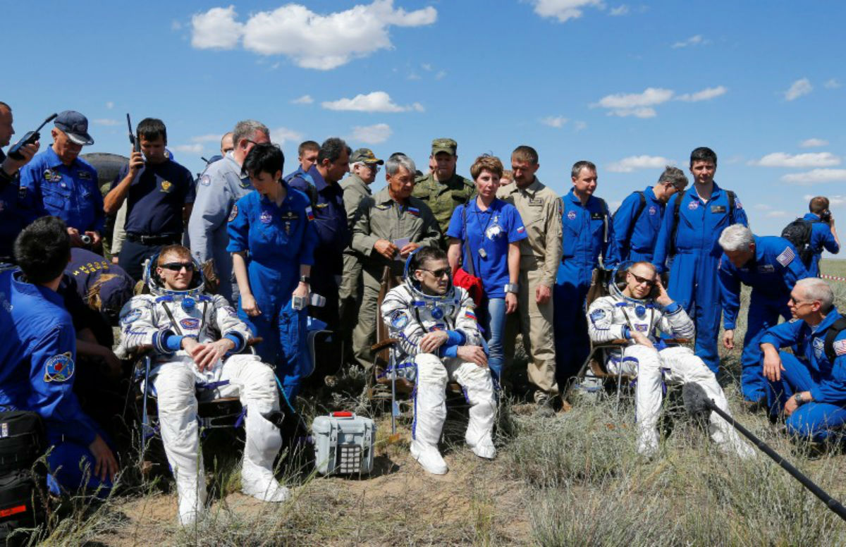This is a photo of The International Space Station (ISS) crew members Timothy Peake of Britain, Yuri Malenchenko of Russia and Timothy Kopra of the U.S., surrounded by ground personnel, rest shortly after landing near the town of Dzhezkazgan (Zhezkazgan), Kazakhstan, June 18, 2016.