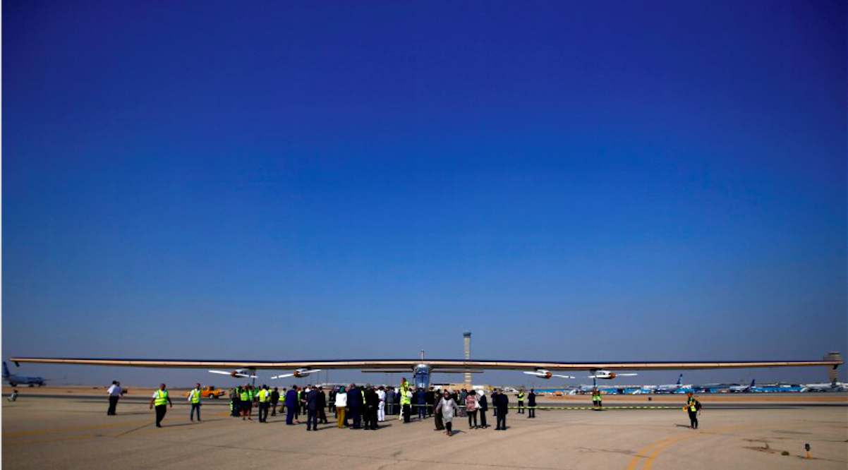 This is a photo of Solar Impulse 2, a solar powered plane, is surrounded by journalists and media after its landing at Cairo Airport, Egypt July 13, 2016.