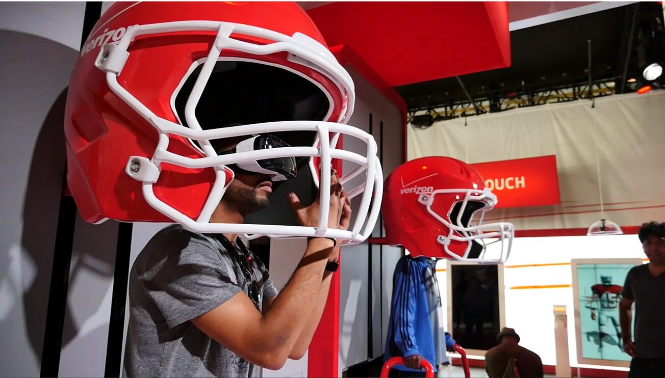 Two Bit Circus' NFL GameTime VR gave 30,000 people a feel for live action at Super Bowl XLIX by putting users in  the cleats of an NFL punt returner. The custom-built oversized helmets were outfitted with surround sound, and vibrating platforms under guests' feet simulated pounding steps on the field. 