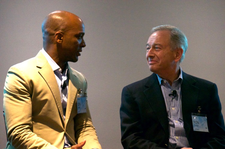 A picture shows Jon Fortt and Ron Fisher speaking