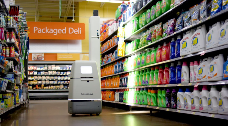 A photo shows one of Bossa Nova's robots at work.