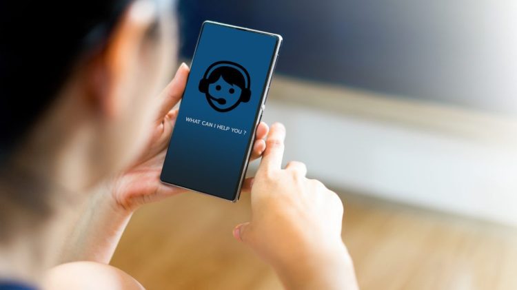 Image of woman talking to conversational AI on her smartphone.