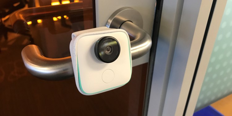 Google's Clips camera clipped onto a door handle.
