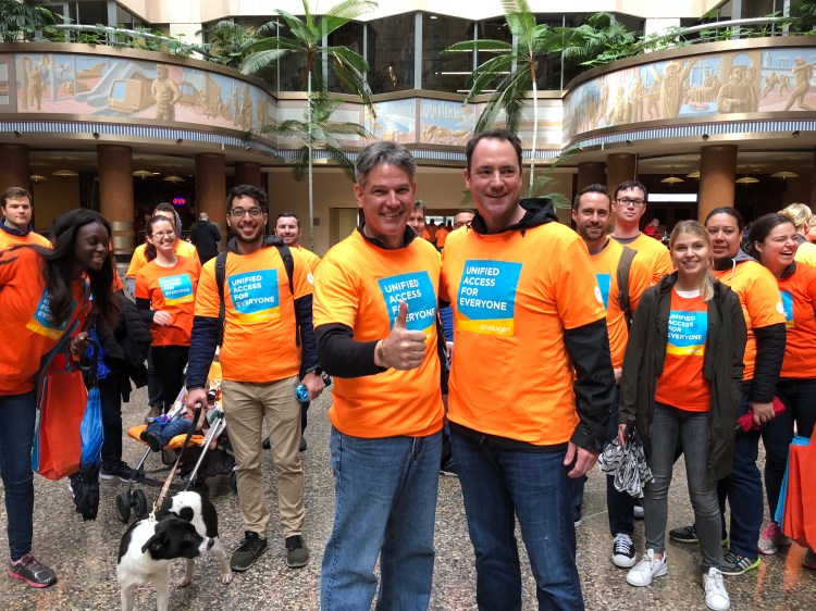 OneLogin employees in orange shirts