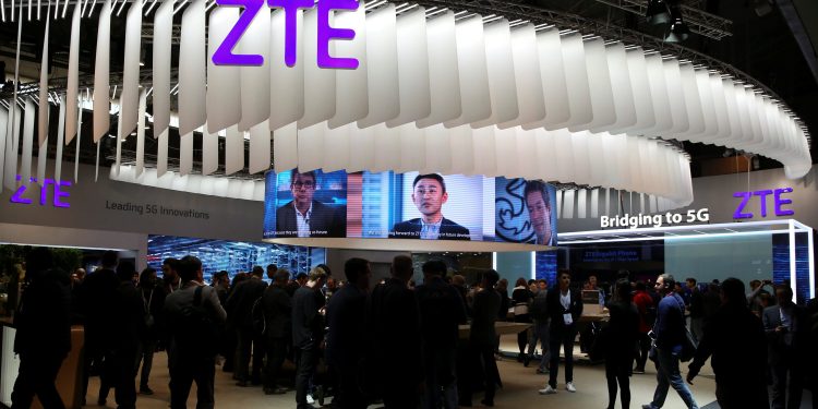 People stand at ZTE's booth during Mobile World Congress in Barcelona, Spain, February 27, 2017.