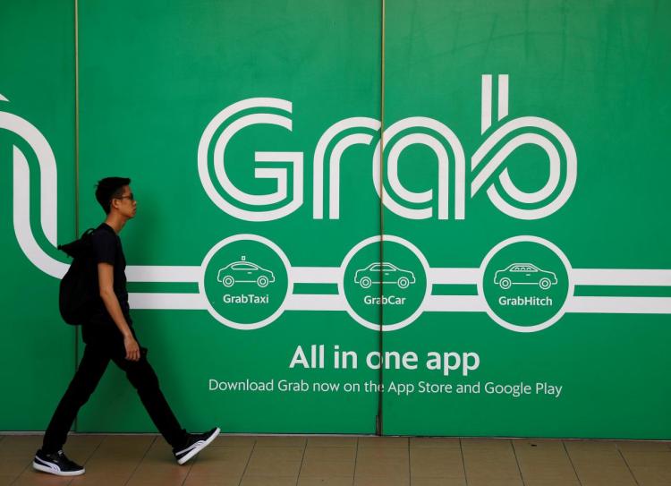 A man walks past a Grab office in Singapore March 26, 2018. 
