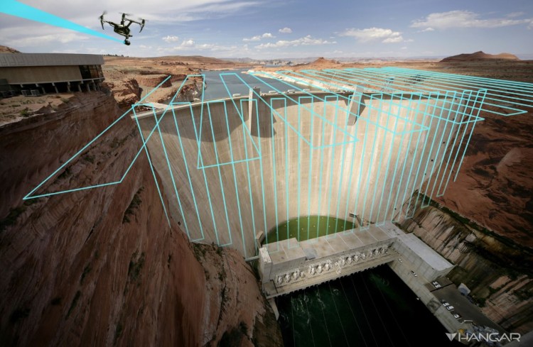Hangar flies a drone over a dam.