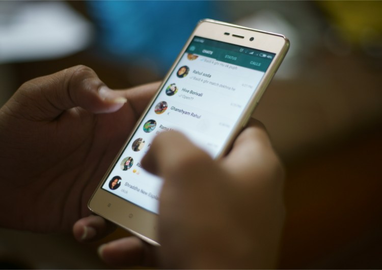 KANDIVALI, MUMBAI, MAHARASHTRA, INDIA - OCTOBER 10, 2017- A man uses WhatsApp on his cell phone at home in Mumbai, India.