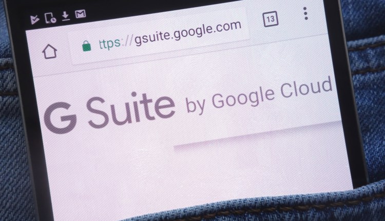 Google G Suite website displayed on smartphone in jeans pocket