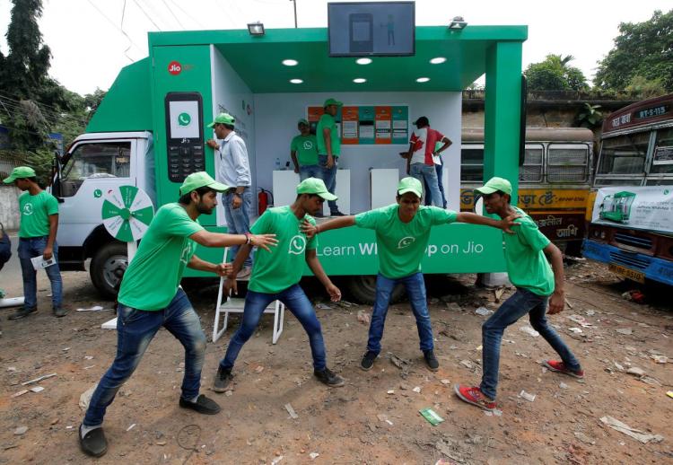 WhatsApp-Reliance Jio representatives perform in a street play during a drive by the two companies to educate users, on the outskirts of Kolkata, India, October 9, 2018. 