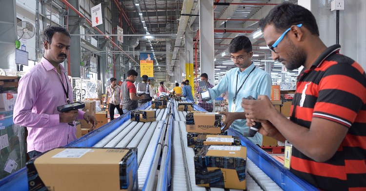 Employees of Amazon India scan packages at Amazon's newly launched fulfilment centre on the outskirts of Bangalore.