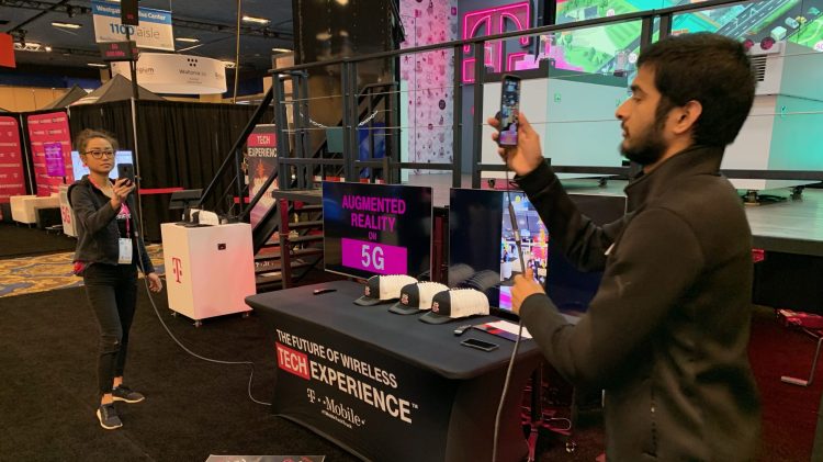T-Mobile booth staffers from the University of Washington demonstrate augmented reality over "5G" at the 2019 CES in Las Vegas.