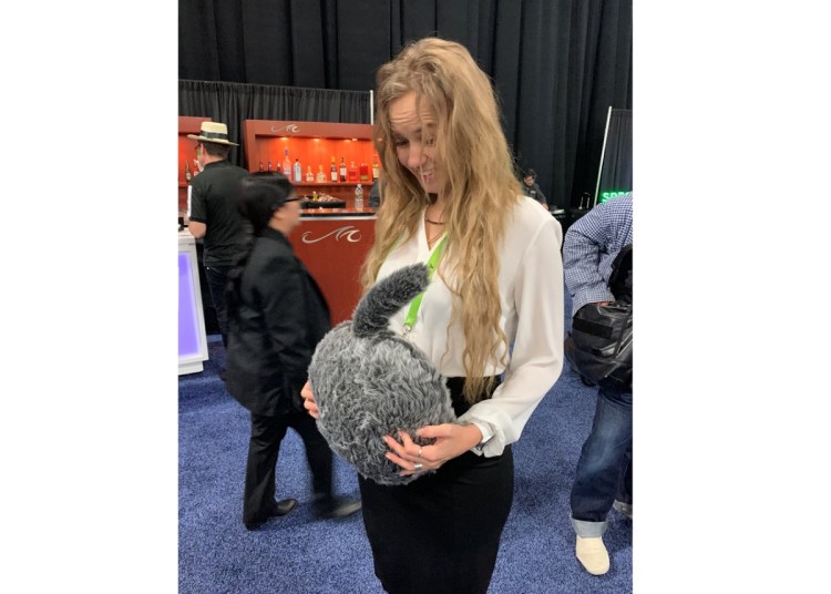 A CES attendee contemplates a new product.