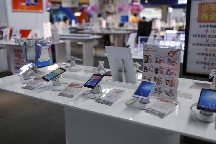 FILE PHOTO: Mobile phones are seen on display at an electronics market in Shanghai, China, June 24, 2015. 