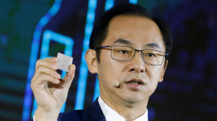 Ryan Ding, the chief of Huawei's carrier business group, holds a Tiangang 5G base station chipset during a product presentation in Beijing, China, January 24, 2019.   REUTERS/Thomas Peter/File Photo