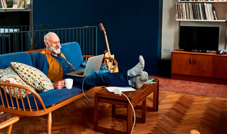 Remote working: Man on sofa... working.