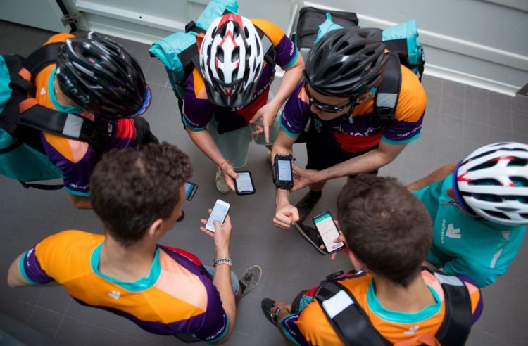 Bikers working for Deliveroo wait for their instructions at one of the first Deliveroo Editions in France kitchens on July 3, 2018.
