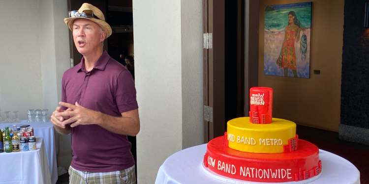 T-Mobile radio engineering SVP Mark McDiarmid discusses the company’s three-layer 5G strategy using a cake with Sprint’s mid-band in the center.