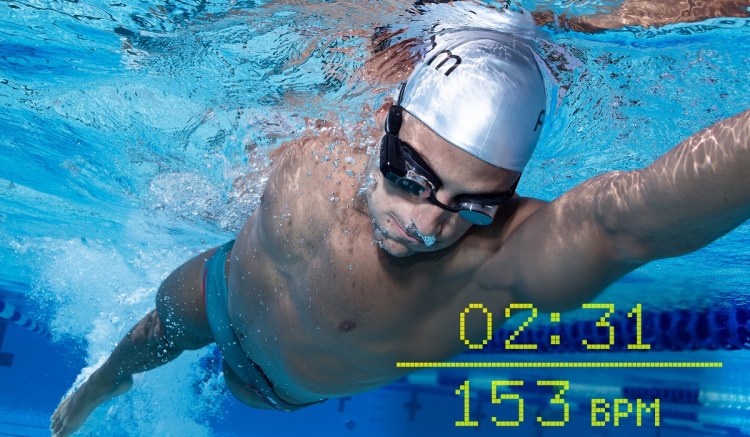 Man swimming with AR swim goggles, with timer and heart rate overlaid on picture