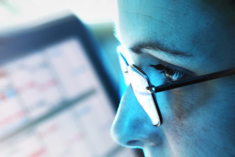 A female executive analyzes details on a screen, data analysis