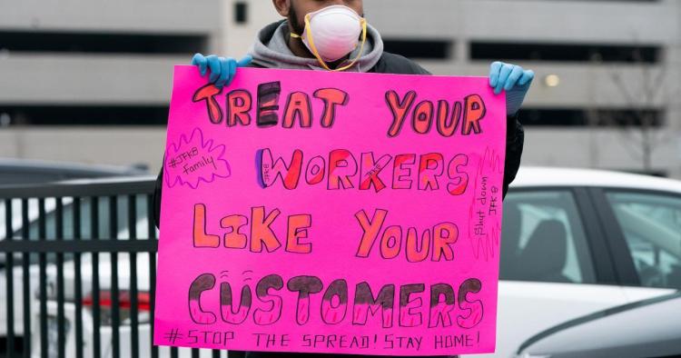 Jordan Flowers holds a sign at Amazon building during the outbreak of the coronavirus disease (COVID-19), in the Staten Island borough of New York City, U.S., March 30, 2020. REUTERS/Jeenah Moon