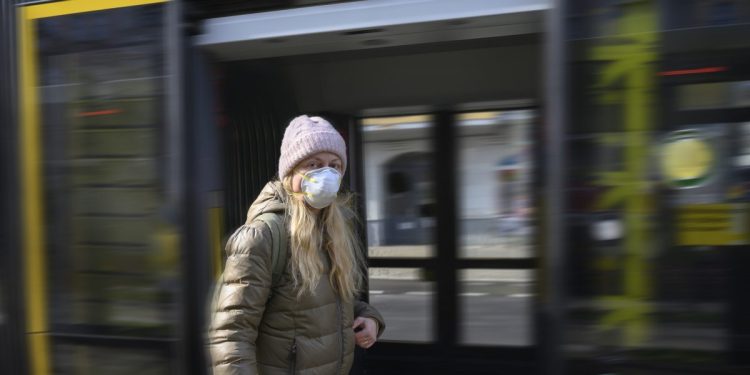 Woman with protective mask on the street