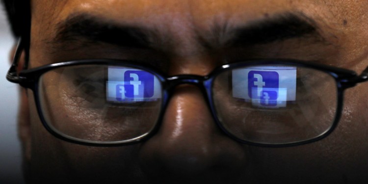 Facebook logo is reflected in glasses in this picture illustration