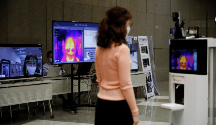 A self-driving robot checks the body temperature of an employee during its demonstration at the headquarters of SK Telecom in Seoul, South Korea, May 26, 2020. Picture taken on May 26, 2020. 