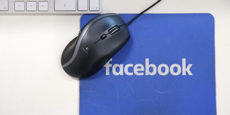 A mousepad with the Facebook logo is seen at Facebook's new headquarters, designed by Canadian-born American architect Frank Gehry, at Rathbone Place in central London on December 4, 2017.