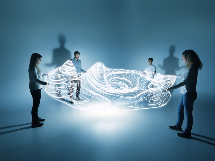 four people viewing digital landscape