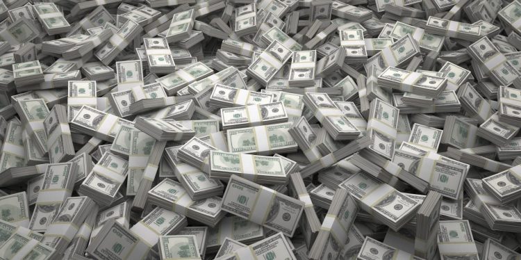 Bundles of $100 US dollar bills scattered randomly. Billions of dollars worth of money spread over the ground and viewed from above. A sea of money and great background.