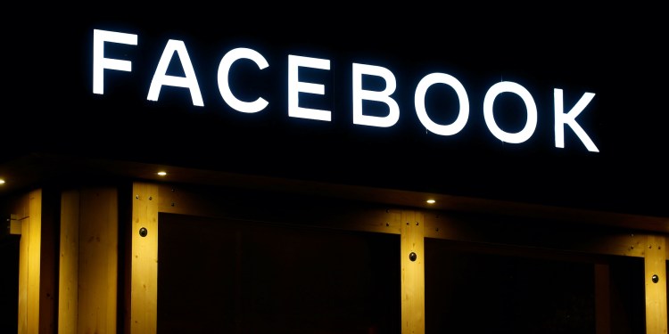 Facebook sign lit up at night