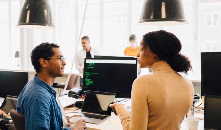 Two team members in discussion