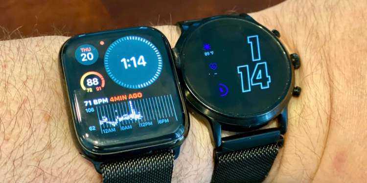 An Apple Watch Series 4 running watchOS 7 next to a Fossil Gen 5 watch running the latest version of Wear OS.