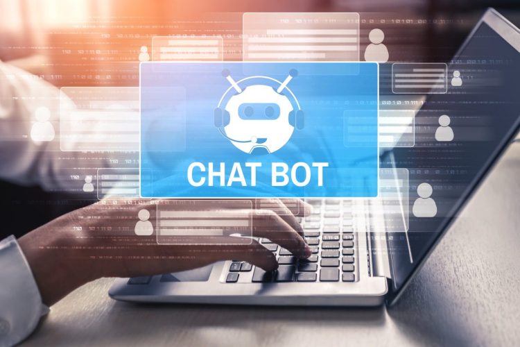 Chatbot icon over a hand typing on a computer keyboard.