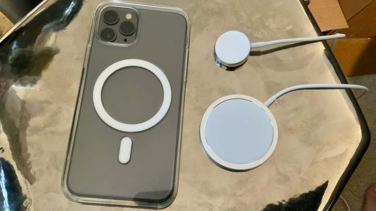 Apple's MagSafe Charger for the iPhone shown alongside the Apple Watch Magnetic Charging Cable and an MagSafe clear case.