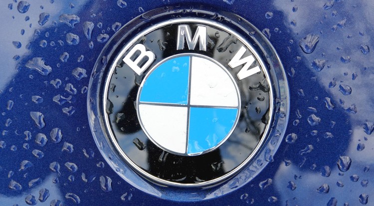 16 November 2020, Berlin: Raindrops on a BMW logo.