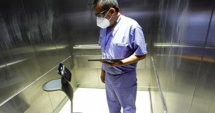 A healthcare worker uses a robot to carry out consultations with patients suffering from the coronavirus disease, at NOVA hospital in Monterrey, Mexico August 18, 2020. Picture taken August 18, 2020. 